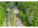 Lush greenery surrounds this home, showcasing a serene and secluded setting from an aerial perspective at 3430 Shorelake Dr, Tucker, GA 30084