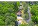Aerial view showcasing a charming home nestled among mature trees, offering privacy and a tranquil setting at 3430 Shorelake Dr, Tucker, GA 30084