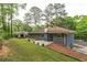 Large backyard featuring a blue painted brick home with a brick chimney and storage shed at 3430 Shorelake Dr, Tucker, GA 30084