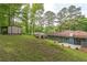 Picture of the large backyard with an outbuilding, storage shed, and blue brick house at 3430 Shorelake Dr, Tucker, GA 30084