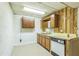 Functional basement kitchenette with wood-paneled cabinets and essential appliances, ready for customization at 3430 Shorelake Dr, Tucker, GA 30084