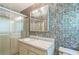 Bathroom featuring a shower, decorative wallpaper, and vanity at 3430 Shorelake Dr, Tucker, GA 30084