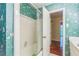 A full bath showcasing a white-tiled shower, a sink, and eye-catching wallpaper at 3430 Shorelake Dr, Tucker, GA 30084