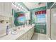 Bathroom boasting a double sink vanity, bright lighting, and a floral wallpaper at 3430 Shorelake Dr, Tucker, GA 30084