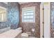 Bathroom boasting a marble countertop sink, and patterned wallpaper at 3430 Shorelake Dr, Tucker, GA 30084