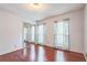 Bedroom with hardwood floors, mirrored closet, and natural light from two windows at 3430 Shorelake Dr, Tucker, GA 30084