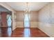 Elegant dining room with hardwood floors, patterned wallpaper, and a decorative chandelier at 3430 Shorelake Dr, Tucker, GA 30084