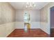 Traditional dining room featuring a chandelier, hardwood floors, and decorative wallpaper at 3430 Shorelake Dr, Tucker, GA 30084