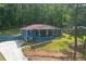 Quaint home with charming curb appeal, featuring a covered porch and lush landscaping at 3430 Shorelake Dr, Tucker, GA 30084