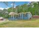 Charming home boasts a covered front porch, blue brick exterior, and well-maintained lawn at 3430 Shorelake Dr, Tucker, GA 30084