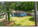 Inviting home with manicured lawn and covered porch, surrounded by lush greenery at 3430 Shorelake Dr, Tucker, GA 30084