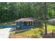 Attractive home with a covered front porch and driveway, nestled among mature trees at 3430 Shorelake Dr, Tucker, GA 30084