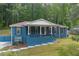 Inviting blue home featuring a cozy front porch and a beautifully manicured lawn, perfect for relaxing outdoors at 3430 Shorelake Dr, Tucker, GA 30084
