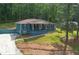 A quaint blue brick home featuring an inviting front porch, set amidst a lush, tree-lined landscape at 3430 Shorelake Dr, Tucker, GA 30084