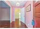 Foyer with beautiful hardwood floors and pink wallpaper, creating a warm and inviting atmosphere at 3430 Shorelake Dr, Tucker, GA 30084