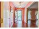 Welcoming foyer with hardwood floors, pink walls, and an open view to the front entrance at 3430 Shorelake Dr, Tucker, GA 30084