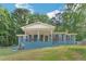 Charming blue brick home with a large front porch and a well-maintained lawn surrounded by mature trees at 3430 Shorelake Dr, Tucker, GA 30084