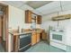 View of the kitchen featuring wood cabinets, white appliances, and light countertops at 3430 Shorelake Dr, Tucker, GA 30084