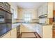 Cozy kitchen with white cabinets, wood floors, and a window above the sink at 3430 Shorelake Dr, Tucker, GA 30084