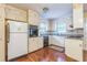 Cozy kitchen with white cabinets, wood floors, and a window above the sink at 3430 Shorelake Dr, Tucker, GA 30084