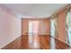 Spacious living room with hardwood floors, pink walls, and natural light from the window at 3430 Shorelake Dr, Tucker, GA 30084