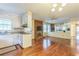Open concept living space with a brick fireplace, wood floors, and a view into the kitchen at 3430 Shorelake Dr, Tucker, GA 30084