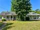 Charming single-story home with a front porch and mature trees and landscaping at 39 N Broad St, Covington, GA 30014