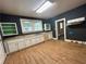 This kitchen features hardwood floors, built in shelves, and abundant natural light from the windows above the sink at 39 N Broad St, Covington, GA 30014