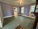 Inviting living room featuring a fireplace, large windows, and a doorway to the kitchen at 39 N Broad St, Covington, GA 30014