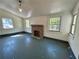Sun-lit living area featuring a classic fireplace, and windows providing a bright airy space at 39 N Broad St, Covington, GA 30014