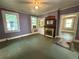 Cozy living space with fireplace, large windows, and doorway, offering a blend of comfort at 39 N Broad St, Covington, GA 30014