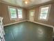 Light-filled living room with large windows, ceiling fan, and space for personalization at 39 N Broad St, Covington, GA 30014
