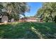 Expansive backyard featuring lush greenery, storage sheds, and a partial fence at 4551 Salem Rd, Covington, GA 30016