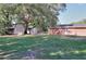 Fenced backyard featuring a lush green space, storage sheds, and privacy trees at 4551 Salem Rd, Covington, GA 30016