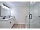 Bathroom with granite-topped double vanity with black hardware, and a glass-enclosed shower at 4551 Salem Rd, Covington, GA 30016