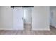 Bedroom with a barn door that leads to a bathroom and a separate entrance/exit door at 4551 Salem Rd, Covington, GA 30016