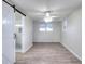 Spacious bedroom features a ceiling fan, two windows, and a sliding barn door to the bathroom at 4551 Salem Rd, Covington, GA 30016