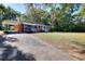 Quaint brick home featuring a covered carport and a lush front yard at 4551 Salem Rd, Covington, GA 30016