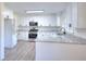 Modern kitchen with stainless steel appliances, white cabinetry, and attractive countertops at 4551 Salem Rd, Covington, GA 30016