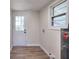 Bright laundry room features a door, window, wood-look flooring, and a Rheem water heater at 4551 Salem Rd, Covington, GA 30016