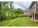 Extensive backyard with lush greenery, mature trees, and a wooden fence, ideal for outdoor activities at 5595 Timson Ln, Johns Creek, GA 30022