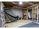 Unfinished basement with a basketball hoop and exposed ceiling, offering potential for customization at 5595 Timson Ln, Johns Creek, GA 30022