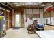 Unfinished basement with a work area, storage, and an exterior door leading to the backyard at 5595 Timson Ln, Johns Creek, GA 30022