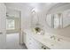 Bathroom features double sinks, white cabinets, and decor at 5595 Timson Ln, Johns Creek, GA 30022