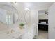 Bathroom with double sinks, white cabinets, and decor at 5595 Timson Ln, Johns Creek, GA 30022