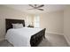 Bedroom boasts a large bed, soft carpet, and abundant natural light at 5595 Timson Ln, Johns Creek, GA 30022