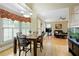 Open-concept dining room with views of the living room and adjacent to the kitchen at 5595 Timson Ln, Johns Creek, GA 30022