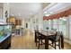 Bright dining room with hardwood floors, large windows, and an adjacent kitchen at 5595 Timson Ln, Johns Creek, GA 30022