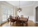 Formal dining room with hardwood floors, wainscoting and a beautiful chandelier at 5595 Timson Ln, Johns Creek, GA 30022