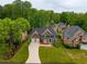 Stately two-story home with a well-manicured lawn, two-car garage, and elegant front entrance at 5595 Timson Ln, Johns Creek, GA 30022